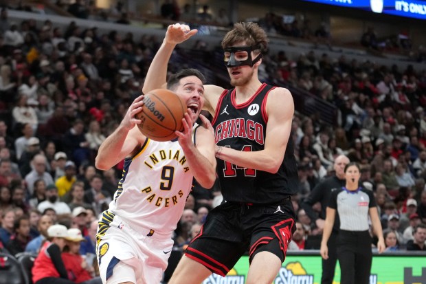 The Pacers' T.J. McConnell drives to the basket as Matas Buzelis defends during the second half on Dec. 6, 2024. (AP Photo/Charles Rex Arbogast)