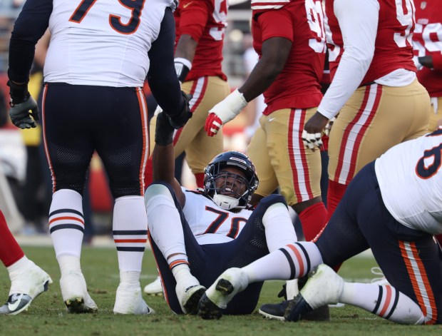 Bears offensive tackle Braxton Jones (70) is helped off the ground in the second quarter against the 49ers at Levi's Stadium on Dec. 8, 2024. (John J. Kim/Chicago Tribune)