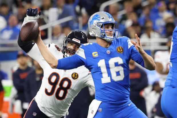 Bears defensive end Montez Sweat, left, chases after Lions quarterback Jared Goff in the first quarter at Ford Field on Nov. 28, 2024, in Detroit. (John J. Kim/Chicago Tribune)