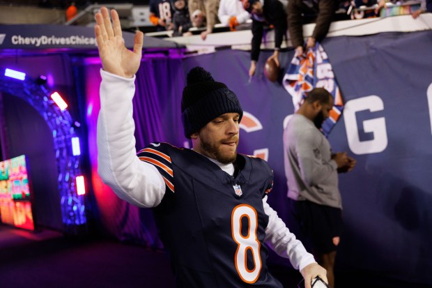 Chicago Bears place kicker Cairo Santos high-fives fans while walking to the field before the Bears play the Seattle Seahawks at Soldier Field on Dec. 26, 2024. (Armando L. Sanchez/Chicago Tribune)