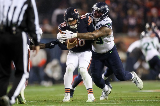 Seattle Seahawks defensive end Leonard Williams (99) sacks Chicago Bears quarterback Caleb Williams (18) during the second quarter at Soldier Field Thursday Dec. 26, 2024, in Chicago. (Armando L. Sanchez/Chicago Tribune)