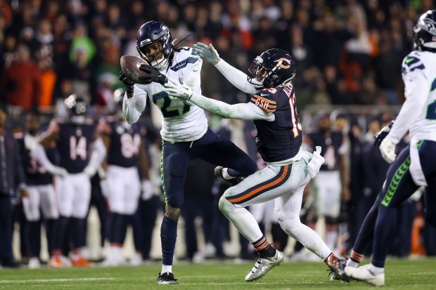 Cornerback Riq Woolen intercepts a pass intended for Bears wide receiver Keenan Allen during the final seconds of the fourth quarter to give the Seahawks a 6-3 win Thursday, Dec. 26, 2024, at Soldier Field. (Armando L. Sanchez/Chicago Tribune)