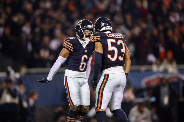 Bears cornerback Kyler Gordon celebrates with linebacker T.J. Edwards after the Bears defense stoped the Seattle Seahawks from getting a first down on third during the fourth quarter at Soldier Field on Dec. 26, 2024. (Armando L. Sanchez/Chicago Tribune)