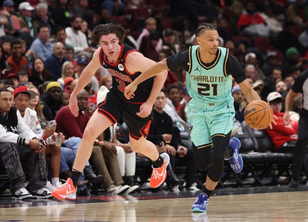 Bulls guard Josh Giddey (3) chases Hornets guard Isaiah Wong (21) in the third quarter at the United Center on Dec. 13, 2024, in Chicago. (John J. Kim/Chicago Tribune)