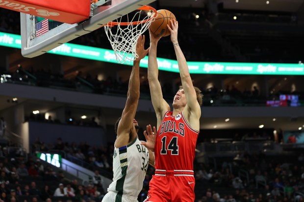 Bulls forward Matas Buzelis dunks against Bucks forward Giannis Antetokounmpo in a preseason game on Oct. 14, 2024, in Milwaukee. (Stacy Revere/Getty Images)