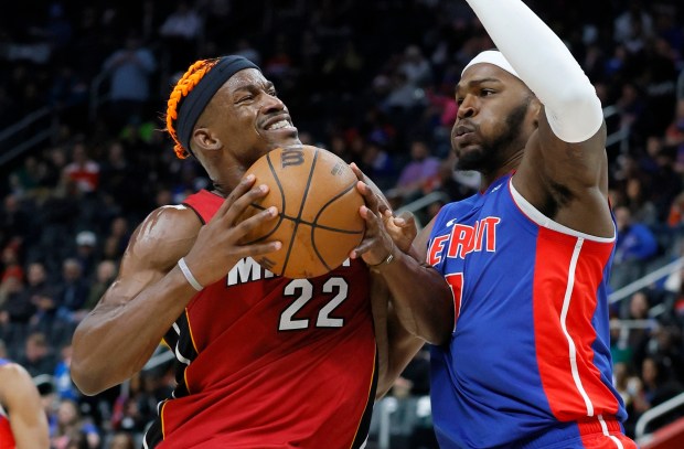 Heat forward Jimmy Butler drives to the basket against Pistons forward Paul Reed on Monday, Dec. 16, 2024, in Detroit. (AP Photo/Duane Burleson)