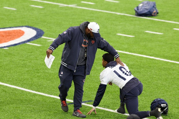 Bears interim coach Thomas Brown pats wide receiver Tyler Scott on the back during practice at Halas Hall on Dec. 4, 2024. (Eileen T. Meslar/Chicago Tribune)