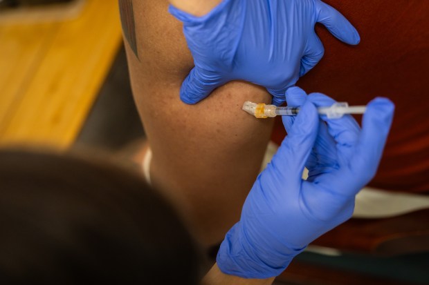 Miguel Angel Sanchez Vega receives an mpox vaccine at a vaccine event at Calor on Oct. 30, 2024. (Tess Crowley/Chicago Tribune)