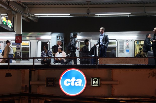 CTA riders are seen on the platform of the Roosevelt station in Chicago on Nov. 4, 2024. (Terrence Antonio James/Chicago Tribune)