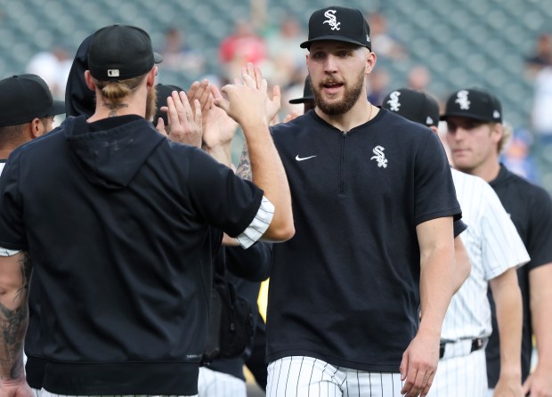 Garrett Crochet high-fives White Sox teammates before a game against the Mariners at Guaranteed Rate Field on July 26, 2024. (John J. Kim/Chicago Tribune)