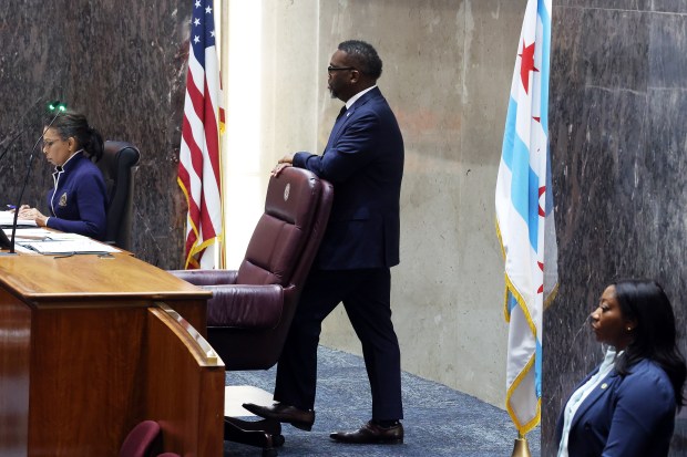 Chicago Mayor Brandon Johnson, center, listens to comments from aldermen during discussion of a proposed city budget during a City Council meeting at City Hall on Dec. 16, 2024. (Terrence Antonio James/Chicago Tribune)