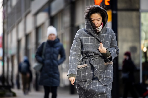 People walk on Grand Street during cold temperatures on Nov. 30, 2024. (Tess Crowley/Chicago Tribune)