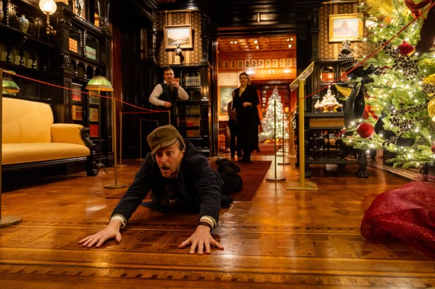 James Sparling, center, acts in "The Ghost of The Crossroads" as part of the performance "Holiday Spirits: A Collection of Victorian Yuletide Ghost Stories" by the Ghostlight Ensemble theater company, adapted by Maria Burnhamat, at the Driehaus Museum in Chicago on Dec. 12, 2024. (Tess Crowley/Chicago Tribune)