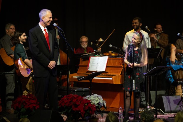 Eric Zorn and Mary Schmich are joined on stage by a band of folk, country and jazz musicians in the annual "Songs of Good Cheer" in Maurer Concert Hall at the Old Town School of Folk Music in Chicago. (Ken Carl)