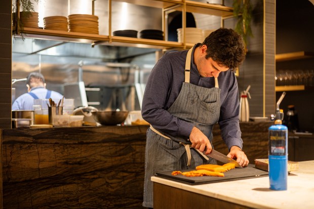 Owner and chef Jake Potashnick prepares food at Feld restaurant on Dec. 18, 2024. (Tess Crowley/Chicago Tribune)