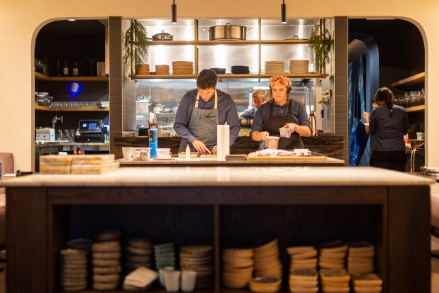 Owner and chef Jake Potashnick, left, and cook Caroline Schrope, center right, prepare food at Feld restaurant on Dec. 18, 2024. (Tess Crowley/Chicago Tribune)