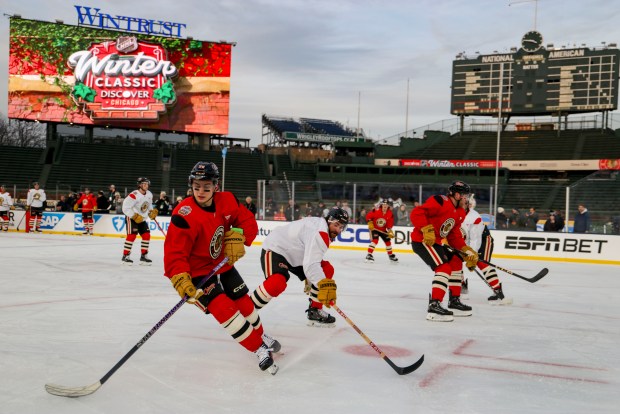 Chicago Blackhawks center Connor Bedard and teammates practice on the ice Monday, Dec. 30, 2024, before facing the St. Louis Blues in the NHL Winter Classic at Wrigley Field. (Brian Cassella/Chicago Tribune)