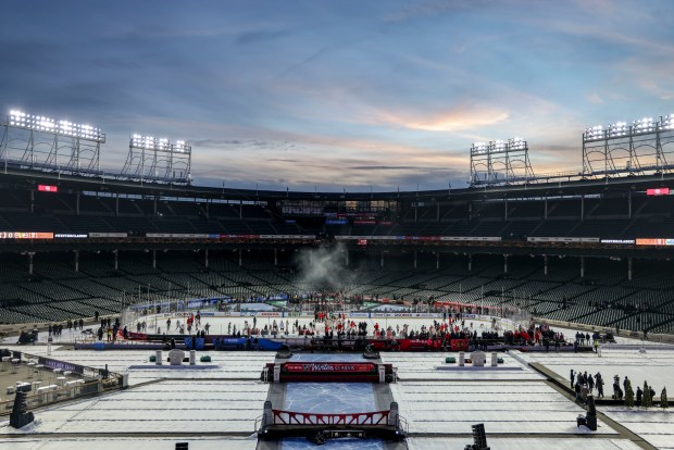 The sun sets while the Chicago Blackhawks skate with family and friends on the ice Monday, Dec. 30, 2024, before facing the St. Louis Blues in the NHL Winter Classic at Wrigley Field. (Brian Cassella/Chicago Tribune)