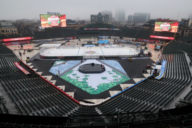 Preparations continue at Wrigley Field on Friday, Dec. 27, 2024, as the baseball diamond is transformed into a hockey rink for the upcoming NHL Winter Classic matchup between the Blackhawks and Blues. (Terrence Antonio James/Chicago Tribune)