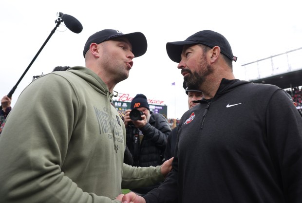 Northwestern coach David Braun, left, and Ohio State coach Ryan Day greet each other after a 31-7 Ohio State win at Wrigley Field on Nov. 16, 2024. (John J. Kim/Chicago Tribune)