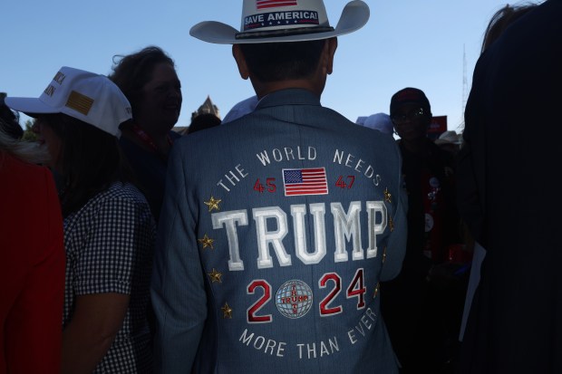 Tien Tran wears a custom-embroidered suit jacket while waiting to enter the final session of the Republican National Convention at Fiserv Forum on July 18, 2024, in Milwaukee. (John J. Kim/Chicago Tribune)