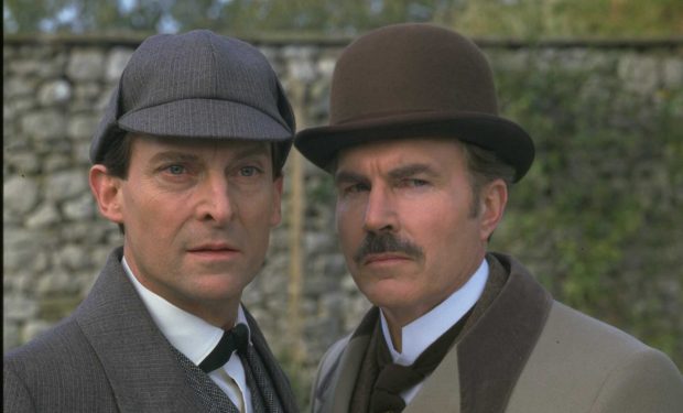 Actors Jeremy Brett (L) and David Burke as Sherlock Holmes and Dr. John Watson in "The Adventures of Sherlock Holmes," circa 1984. (TV Times via Getty Images)