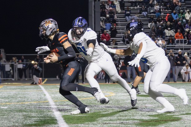 Lincoln-Way East's Caden O'Rourke (91) sacks Minooka's Zane Caves during a Class 8A second-round playoff game in Minooka on Nov. 8, 2024. (Troy Stolt/For the Daily Southtown)