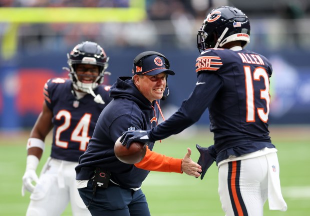 Bears offensive coordinator Shane Waldron congratulates wide receiver Keenan Allen after Allen scored a touchdown against the Jaguars at Tottenham Hotspur Stadium in London on Oct. 13, 2024. (Chris Sweda/Chicago Tribune)