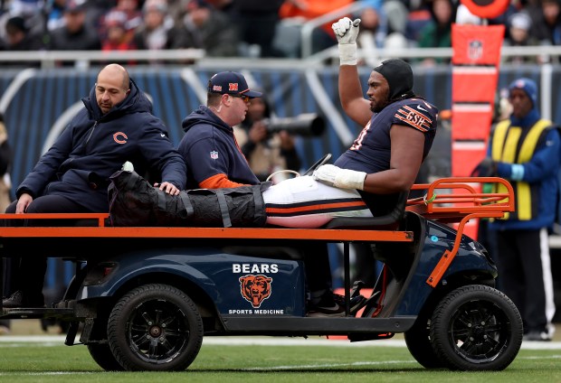 Chicago Bears offensive tackle Braxton Jones (70) is carted off the field after suffering an injury in the second quarter of a game against the Detroit Lions at Soldier Field in Chicago on Dec. 22, 2024. (Chris Sweda/Chicago Tribune)