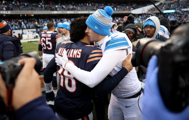 Bears quarterback Caleb Williams (18) and Detroit Lions quarterback Jared Goff (16) embrace after a Lions victory over the Bears at Soldier Field on Dec. 22, 2024. (Chris Sweda/Chicago Tribune)