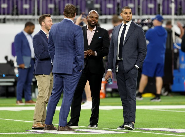 Chicago Bears general manager Ryan Poles (right) stands on the field before the start of a game against the Minnesota Vikings at U.S. Bank Stadium in Minneapolis. (Chris Sweda/Chicago Tribune)