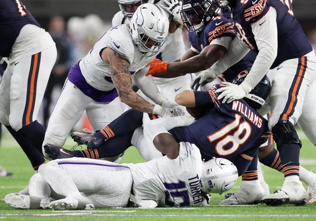 Minnesota Vikings linebacker Dallas Turner (15) sacks Chicago Bears quarterback Caleb Williams (18) in the fourth quarter of a game at U.S. Bank Stadium in Minneapolis on Dec. 16, 2024. (Chris Sweda/Chicago Tribune)