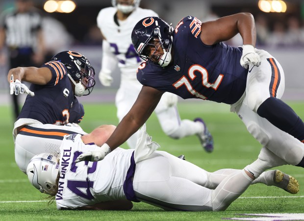 Bears offensive tackle Kiran Amegadjie falls to the turf while trying to block Vikings linebacker Andrew Van Ginkel in the third quarter of a game at U.S. Bank Stadium in Minneapolis on Dec. 16, 2024. (Chris Sweda/Chicago Tribune)