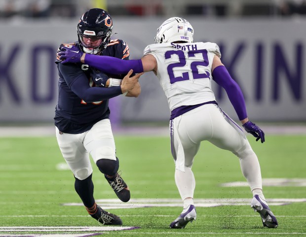 Bears quarterback Caleb Williams tries to run through the tackle of Vikings safety Harrison Smith in the first quarter at U.S. Bank Stadium in Minneapolis on Dec. 16, 2024. (Chris Sweda/Chicago Tribune)