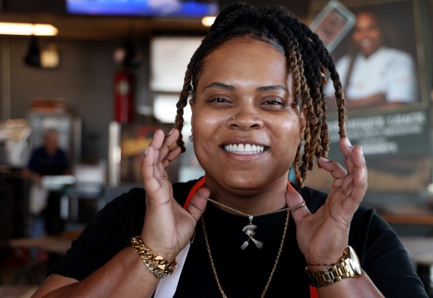 Dominique Leach, chef and owner of Lexington Betty Smokehouse, in Chicago's Pullman neighborhood, wears her favorite gift - a custom chain with a chef's hat, whisk and fork. The gift was given to her by her wife. (Antonio Perez/Chicago Tribune)