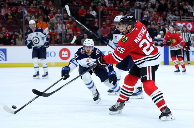 Chicago Blackhawks defenseman Alec Martinez (25) shoots and scores in the first period of a game against the Winnipeg Jets at the United Center in Chicago on Dec. 7, 2024. (Chris Sweda/Chicago Tribune)