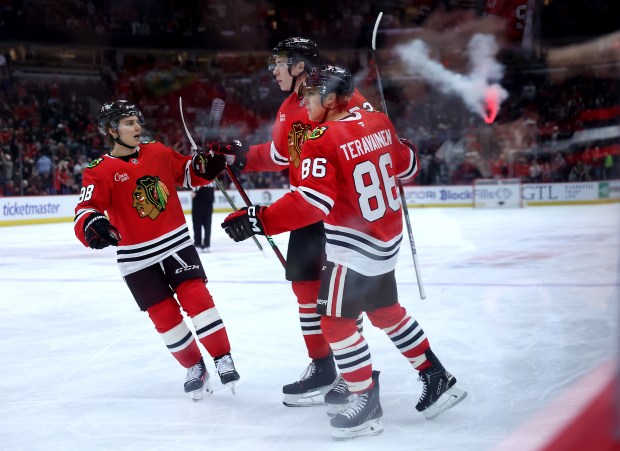 Chicago Blackhawks defenseman Alex Vlasic (center) celebrates with teammates Connor Bedard (left) and Teuvo Teravainen (86) after Vlasic scored a goal in the first period of a game against the Winnipeg Jets at the United Center in Chicago on Dec. 7, 2024. (Chris Sweda/Chicago Tribune)