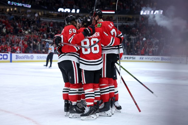 Chicago Blackhawks defenseman Alex Vlasic (right) celebrates with his teammates after scoring a goal in the first period of a game against the Winnipeg Jets at the United Center in Chicago on Dec. 7, 2024. (Chris Sweda/Chicago Tribune)