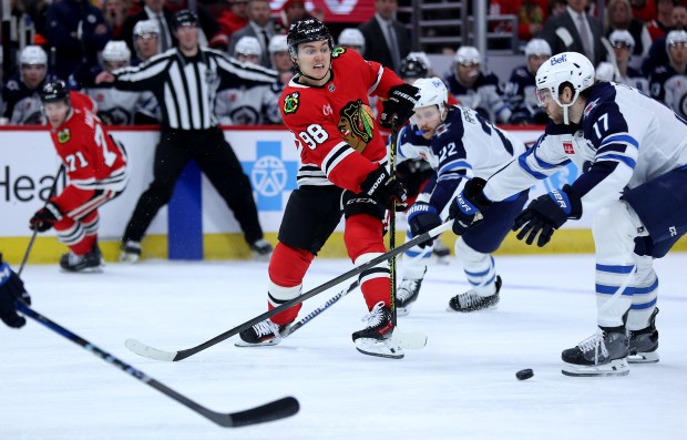 Chicago Blackhawks center Connor Bedard (98) makes a pass in the third period of a game against the Winnipeg Jets at the United Center in Chicago on Dec. 7, 2024. (Chris Sweda/Chicago Tribune)