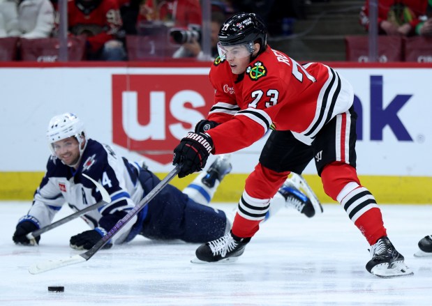 Chicago Blackhawks left wing Lukas Reichel (73) looks to gain control of the puck in the second period of a game against the Winnipeg Jets at the United Center in Chicago on Dec. 7, 2024. (Chris Sweda/Chicago Tribune)