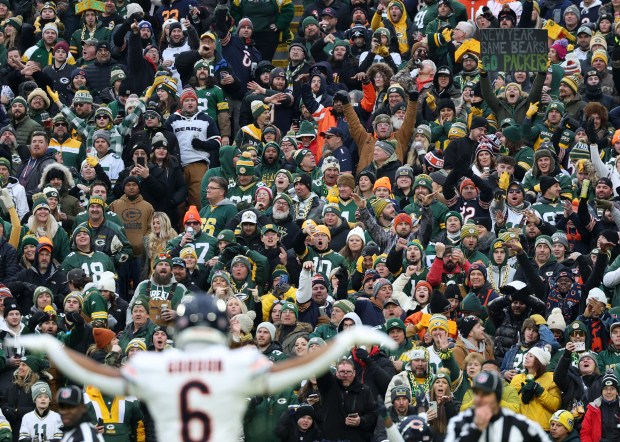 A Packers fan holds a sign to show to Bears cornerback Kyler Gordon (6) in the first quarter at Lambeau Field on Jan. 7, 2024, in Green Bay. (John J. Kim/Chicago Tribune)