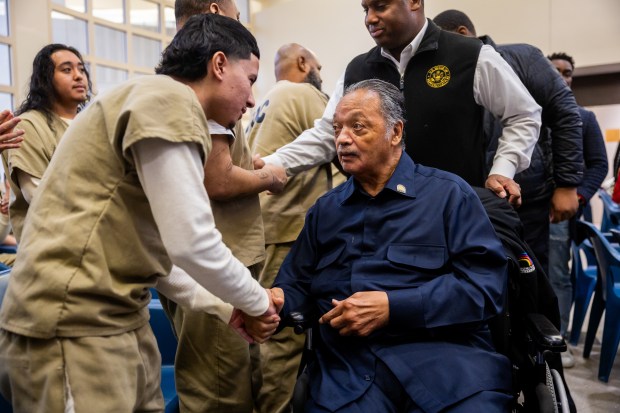 Rev. Jesse Jackson, right, shakes hands with people in custody after speaking during Rainbow PUSH Coalition's Christmas Day service at Cook County Jail on Dec. 25, 2024. (Tess Crowley/Chicago Tribune)