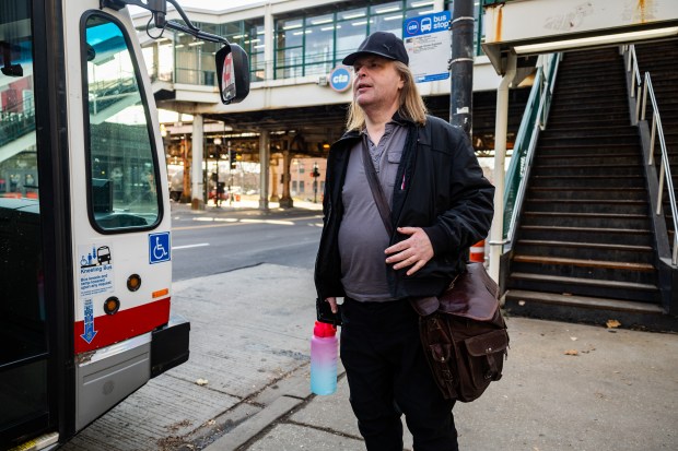 Andrew Perdiue waits for the CTA #4 bus in the Woodlawn neighborhood on Dec. 10, 2024. (Tess Crowley/Chicago Tribune)