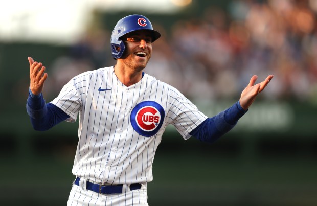 Cubs center fielder Cody Bellinger has a laugh with members of the Cardinals while standing at first base after singling on July 20, 2023, at Wrigley Field. (Chris Sweda/Chicago Tribune)