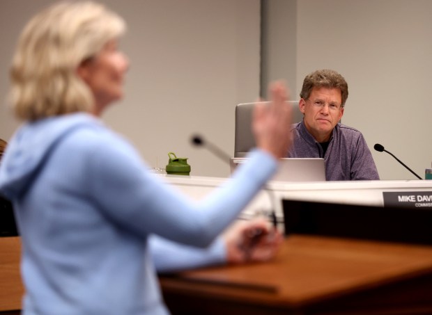 Downers Grove commissioner Michael Davenport listens as residents speak on the topic of a proposed nonbonding referendum on the village's public library during a regular village council meeting on Dec. 3, 2024. (Chris Sweda/Chicago Tribune)