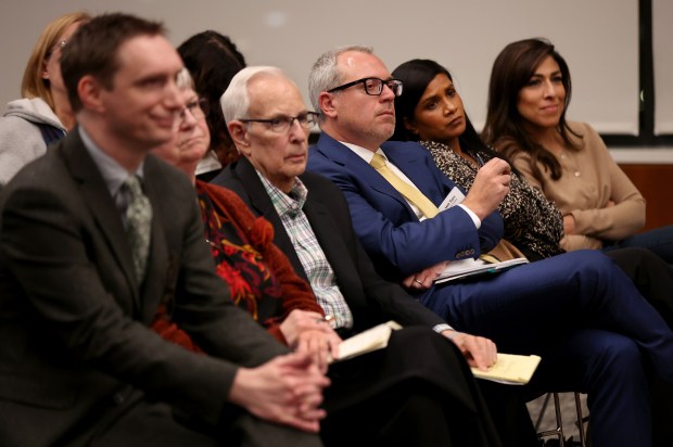 Matt Topic, president of the Downers Grove Public Library board of trustees, third from right, sits among fellow trustees as the proposed nonbonding referendum on the village's public library is discussed during a regular village council meeting on Dec. 3, 2024. (Chris Sweda/Chicago Tribune)