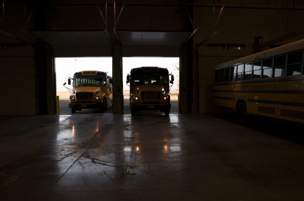 Herscher district electric school buses pull into the new garage, built in fall 2024, to charge on Dec. 17, 2024. (Eileen T. Meslar/Chicago Tribune)