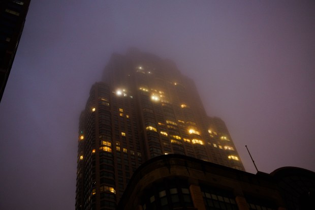 Lights from a building illuminate clouds as rain falls near Michigan Avenue in Chicago on Nov. 18, 2024. (Armando L. Sanchez/Chicago Tribune)