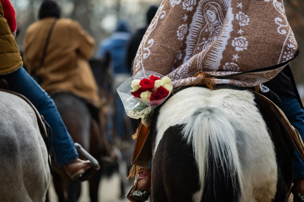 Our Lady of Guadalupe appears on a blanket as riders from Club Los Vaqueros Unidos head to the Shrine of Our Lady of Guadalupe on Dec. 7, 2024. (Tess Crowley/Chicago Tribune)