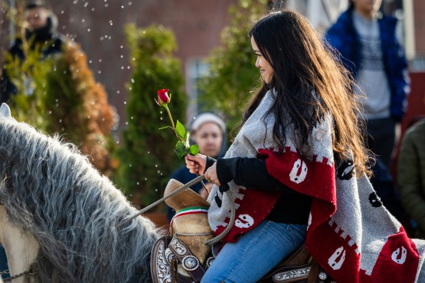 A horseback rider from Club Los Vaqueros Unidos is sprayed with holy water at the Shrine of Our Lady of Guadalupe in Des Plaines on Dec. 7, 2024. (Tess Crowley/Chicago Tribune)